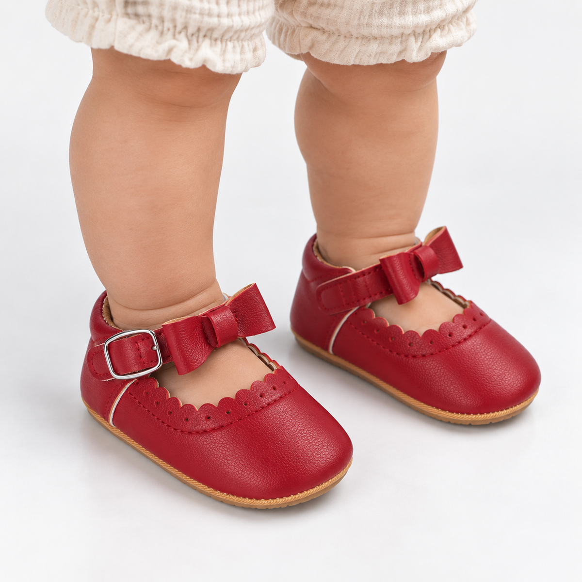 Chaussures premiers pas bébé fille rouges à nœud festonné